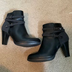 Black faux leather heeled booties with buckles and zipper on the side
